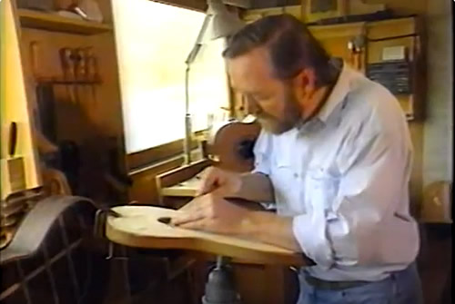 Photo of Oskar working on a guitar in his Clarendon workshop